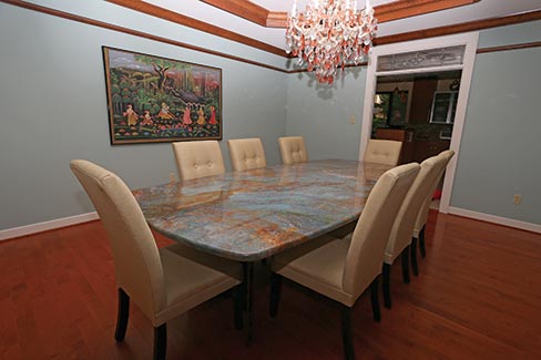  A stunning, one-of-a-kind, Blue Louis granite dining table fabricated by Arch City Granite & Marble is the crowning glory of this formal dining room of an upscale St. Louis residence. 