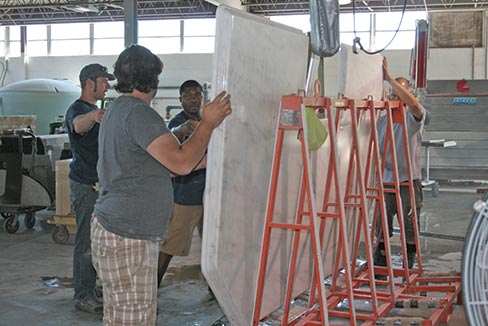 A 2.5 inch thick laminated Danby marble island is being prepared to ship for installation. Custom CNC edges like this are a specialty of Arch City Granite & Marble Inc. 
