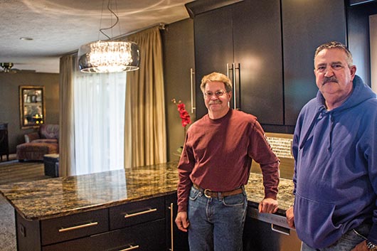 Ron Brown, owner of Artistic Marble and Granite, in the newly renovated kitchen of his client and fellow contractor, Steve Shaffer