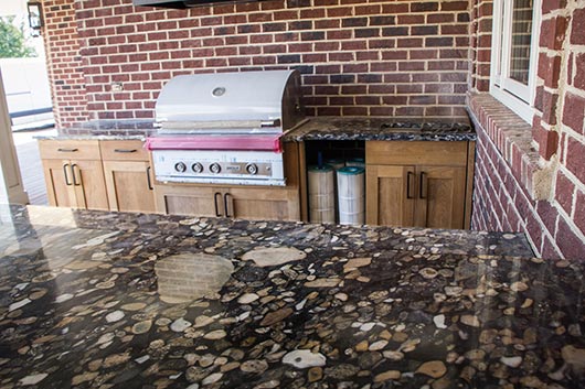 The bold, graphic pebble shapes in this bar and grill space make the Brazilian Black Marinace granite  popular for outdoor use. With Brown’s skillful templating work the shapes are full and seamless. 
