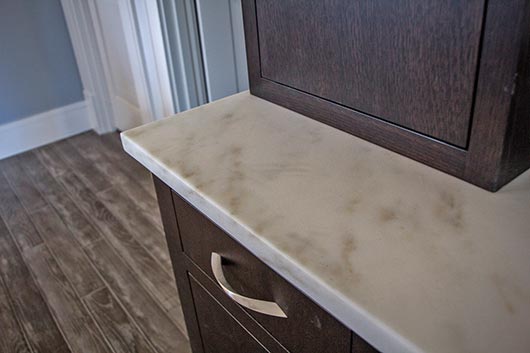 White Imperial Danby marble is featured throughout the ground floor kitchen and den area of this home. Brown is responsible for making each template.  Although straight cuts were used in many of the projects, there is a lot of marble in this house - $68,000 worth so far, and the project keeps growing.