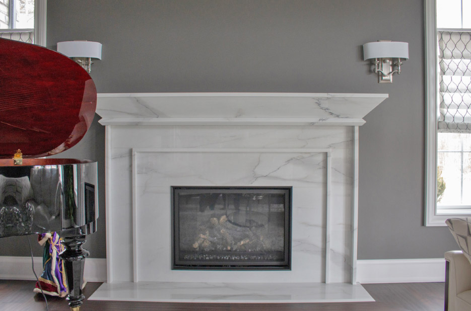 Mitered and vein-matched Calacatta Lincoln marble fireplace designed for a residential customer.
