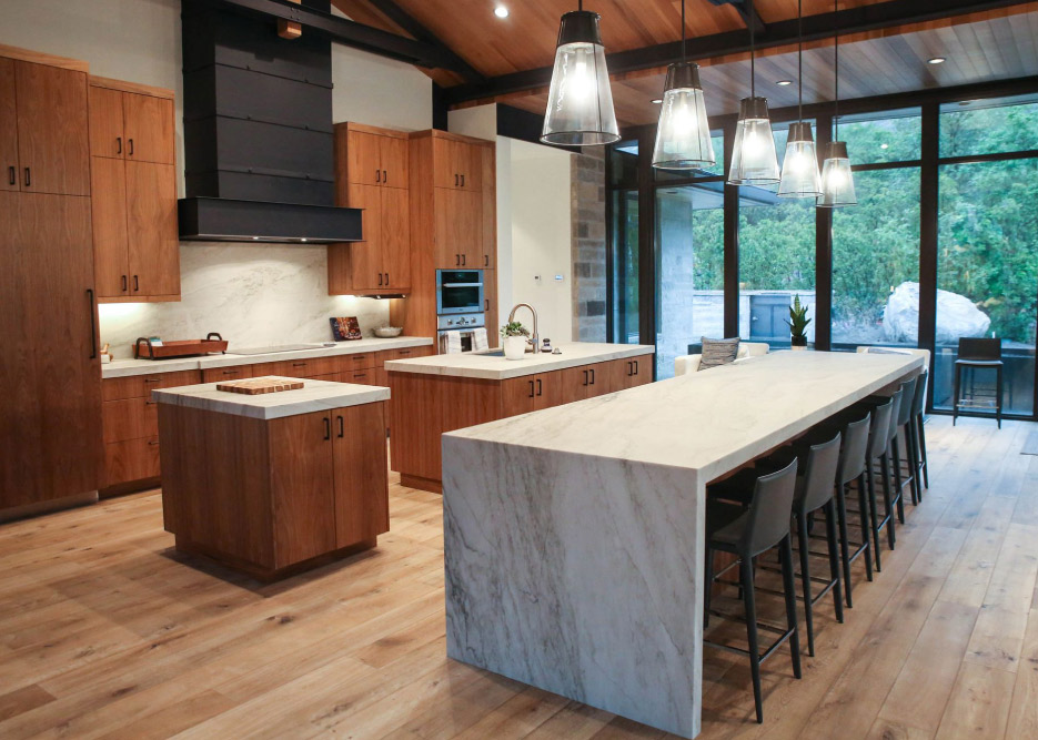 A dramatic White Pearl Quartzite waterfall table is the centerpiece of this spacious open plan room.