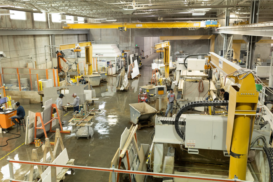 The Bedrock fabrication shop uses jib and bridge cranes outfitted with vacuum lifters by Woods or Manzelli to move materials through the OSHA-compliant wet shop