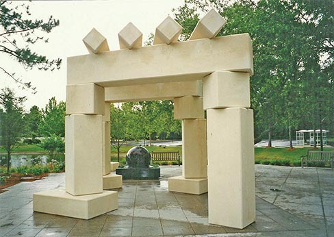 This Cordova Creme limestone structure was fabricated by Southern Granite Company, Inc., for a scenic meditation area on a lake-island park on the grounds of the Mayo Clinic hospital in Jacksonville, Florida. The Southern Granite Co. also supplied the granite ball fountain. The lattice is approximately 17x17 foot, with the upper segments supported by three columns set on 18 inch-high, rectangular bases, one free-standing. Set on angles, no two exactly alike, it weighs 126 tons and can withstand winds up to 180 miles per hour.