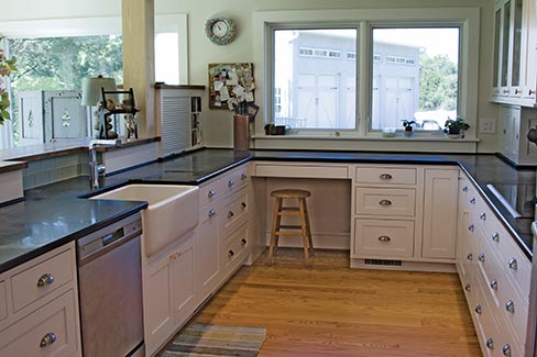 Polished finish Church Hill Black soapstone counters from the Old Dominion quarry complement this well-appointed country kitchen. 