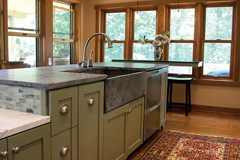 This contemporary kitchen stove island, backsplash and bar use lightly polished American Original soapstone to great effect. American Original soapstone is sourced from the Old Dominion Quarry in Albemarle County, Virginia. 