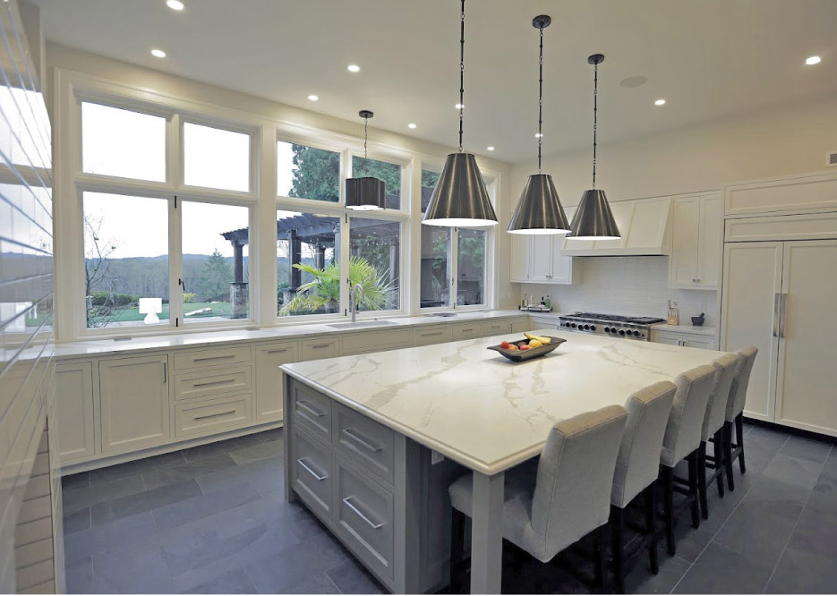 Quartz kitchen features extra-long counters and a spacious island work station / dining table.