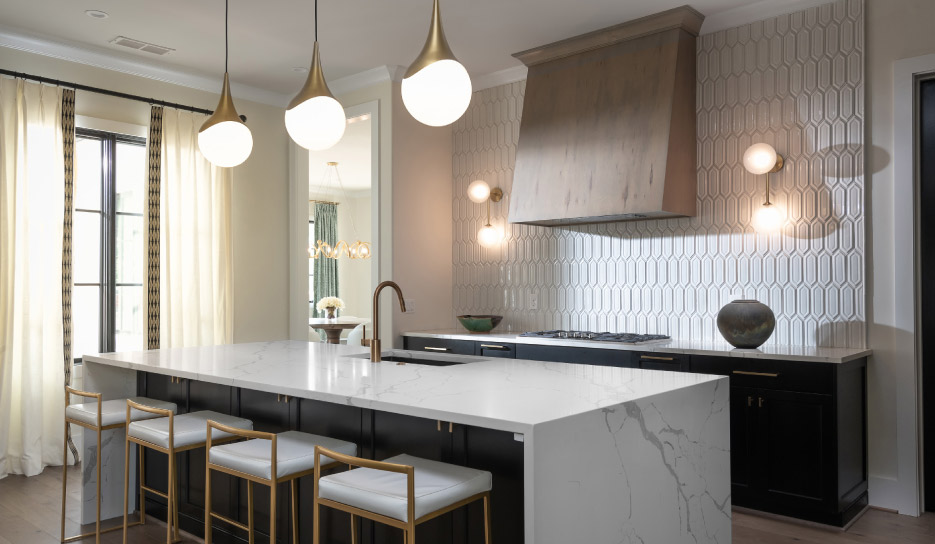 Open plan residential kitchen features Calacatta Laza polished quartz with full-sized eased double waterfall island.