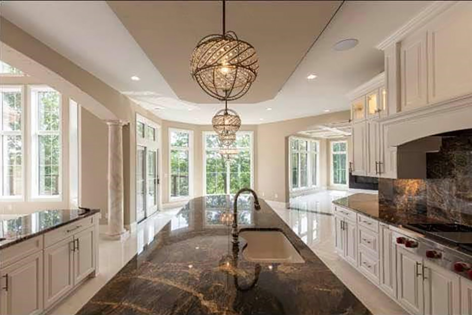 Lava Oro granite kitchen island, countertops and backsplash, produced and installed for a Wisconsin builder client who specializes in large-scale homes. 
