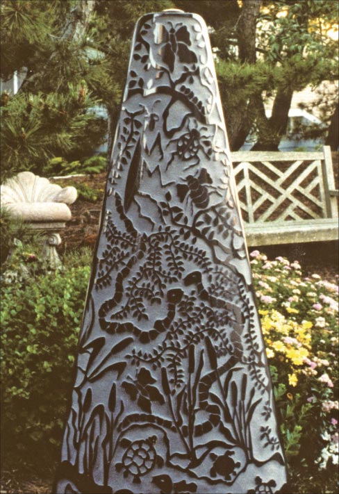 “Menagerie” is one of Julie’s first sculptures in her Stone Drawings series. This bas-relief series evolved several years ago after she visited Egypt, where she was greatly impressed by the grand scale of the monuments, which were covered in chiseled hieroglyphics and historical illustrations still clear and visible after over two thousand of years of weathering. After the trip, she began to create columns, wall panels, garden discs and other sculptural shapes where she has depicted a variety of animal, plant and human forms deeply sandblasted into the stone. The polished, bas-relief designs are a dramatic tonal contrast to the revealed, lighter tones of the sandblasted granite.