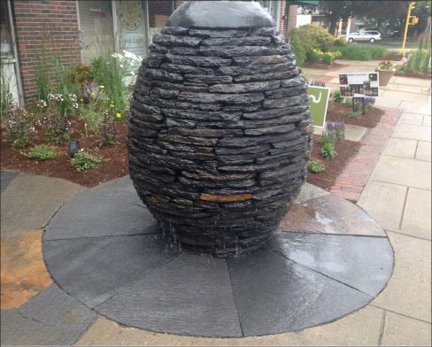 This fountain features fleuri cut Quicksilver schist flags, and rough, chisel cut stacked schist.