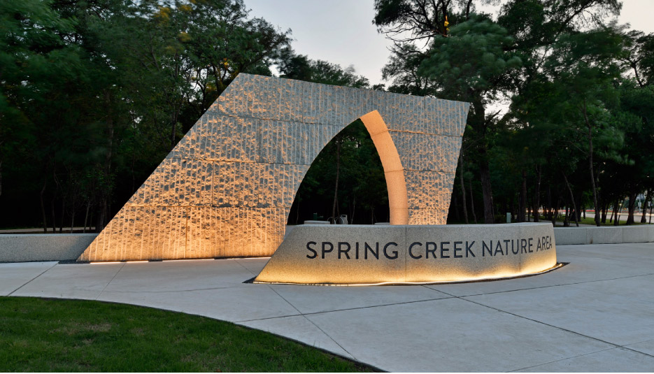 Massive blocks of Kenoran Sage granite become nature-inspired entry portals into a peaceful reprieve from the hectic Dallas-Fort Worth Metroplex.