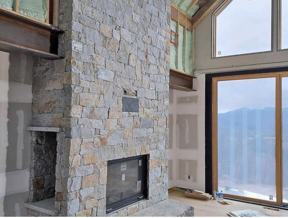 Fireplace featuring Spruce Mountain stone, strip construction.  Stone provided by New Hampshire Thinstone.