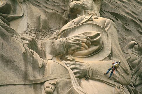 Mark Lassiter inspects a “dutchman” repair at General Lee’s elbow for signs of wear. There are ten such repairs in the whole gigantic carving