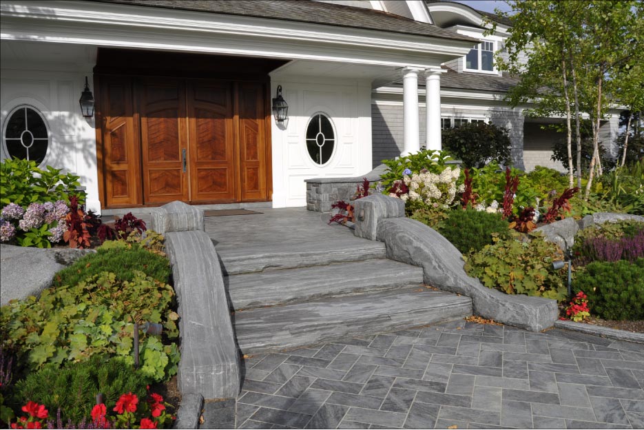 This eight foot wide entryway is custom fabricated out of J. C. Stone’s Heritage Valley stone. Ucci also extensively surrounded this Southport, Maine estate with stone veneer, an exterior fireplace, patio, walls, gateposts, gazebo, and hot tub with pool waterfall and coping.