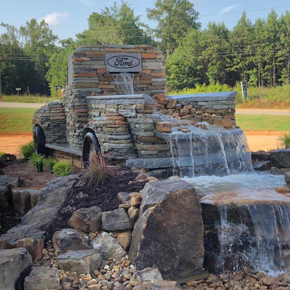 Miller hauled the Barre granite pieces to the site in a trailer. An aquatic specialist has made a water feature that pours into the back window, then into the bed, then cascades in a series of waterfalls, to eventually spill into a pond. 