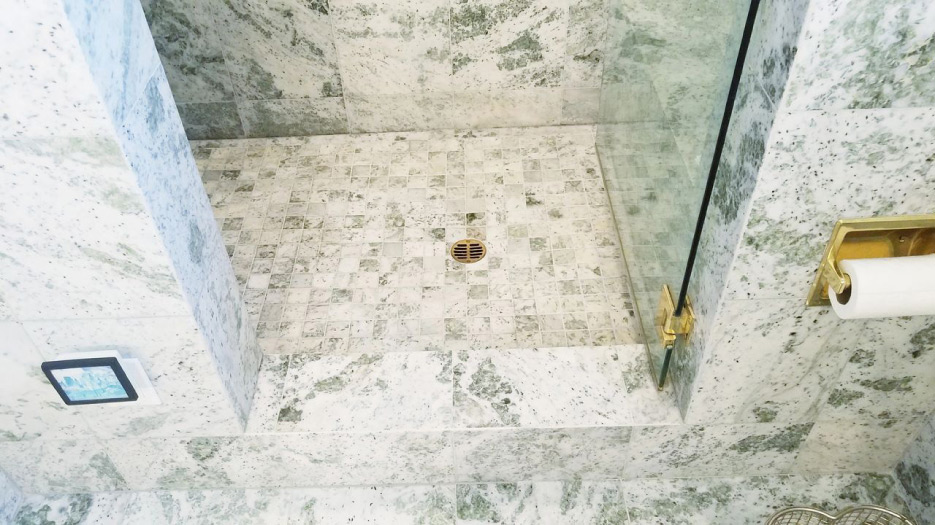 This 20-year-old marble shower had no water discoloration problems due to the dry-pack mortar bed and traditional water-in/water-out installation system.