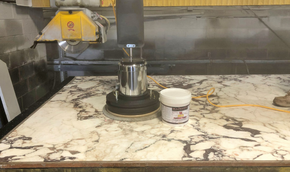 The idea is to load the slab on the CNC gantry saw turntable and repolish the slab using a floor machine. With many years of experience, polishing on the bed of a saw is not too difficult for me, but is still dangerous. I recommended a bumper system be installed to help with fall safety issues.