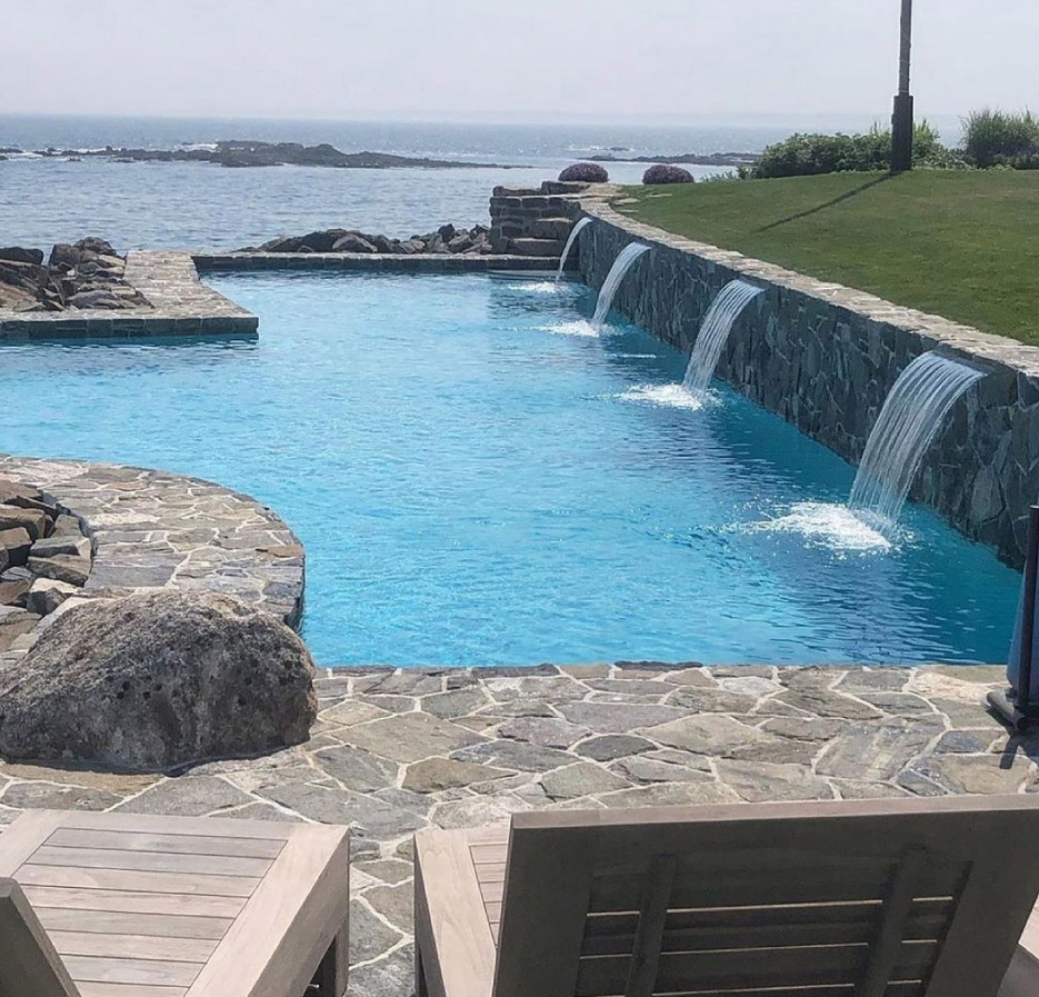 Fitzwilliam granite full bed fountain. Backsplash, fountain, and retaining wall by Sudbury Design Group in Massachusetts.