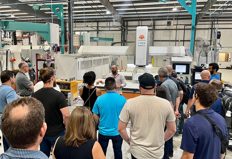 Oklahoma City conference attendees at a demo of the Poseidon Industries  T-Rex machine during an enriching visit to Starlumber.