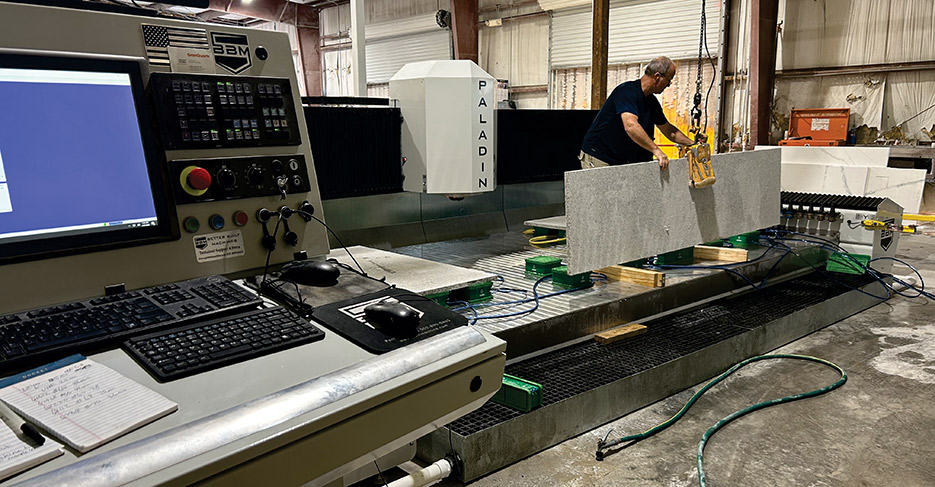 A fabricator at Distinctive Surfaces of Florida effortlessly loads a countertop onto the PALADIN’s large table bed, which is free of safety cables that can get in the way. The PALADIN is, instead, equipped with a safety laser, improving accessibility. 