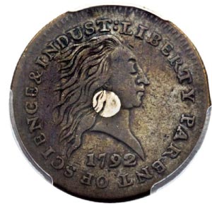 This undated photo provided by Heritage Auctions show the front and of a 1792 “Silver Center Cent.” The one-cent coins just auctioned off are two rare 1792-dated coins made during the early years of the U.S. mint.