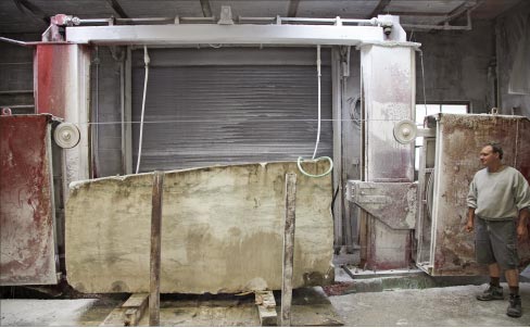 Gawet Marble & Granite’s wire saw was custom built to fit their shop. They had a roof restriction and a length restriction, so this compact wire saw exactly fits the facility. Co-owner Philip Gawet commented, “It’s been wonderful, but it’s 20 years old, and yes, we’ve rebuilt it. It has got to be rebuilt again. We’re thinking about purchasing another one and putting it outdoors – under roof, of course.” 