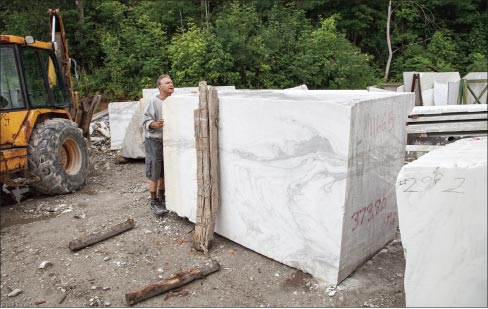 Co-owner Phil Gawet inspecting one of the prime-quality blocks stored in their stoneyard. “My father bought blocks and stockpiled them. This one would be good for memorials. Many blocks are a combination of colors. Most are usable for large– or small-scale projects, including sculpture.” 