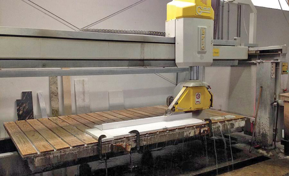 The shop fabricates using an AccuGlide Miter Workstation, Makita grinders, two bridge saws — one from Gregori and the other a GMM Brio bridge saw, a Hercules Edge Router from BB Industries, and radial arm face polishers.