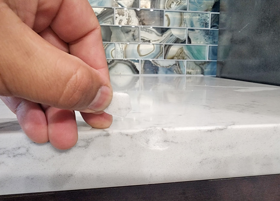 The Granite Gold Countertop Protection Plan covers the repair of chips and other accidental damages at no additional cost to the customer. Here is one of their methods to achieve a superior repair to a quartz countertop chip: color matching the repair epoxy, polishing, and cleanup.