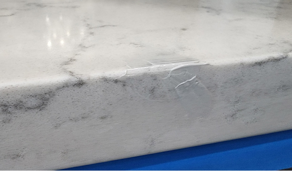 The Granite Gold Countertop Protection Plan covers the repair of chips and other accidental damages at no additional cost to the customer. Here is one of their methods to achieve a superior repair to a quartz countertop chip: color matching the repair epoxy, polishing, and cleanup.