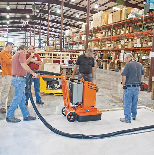 Brian directs the hands-on floor grinding session, and the sealing process
