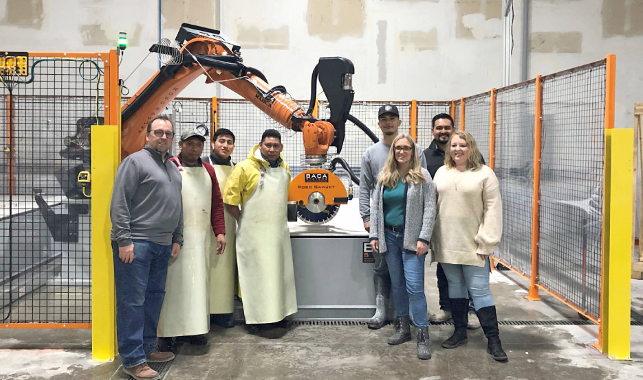 From left:  Don Benton and some of the Granite and Marble Solutions team with and their BACA Robo SawJet, installed in February 2021. Recent shop machinery upgrades include a Marmo Meccanica – LCV711M  Vertical Line Polisher, and a Gorbel jib crane to handle moving and loading material.