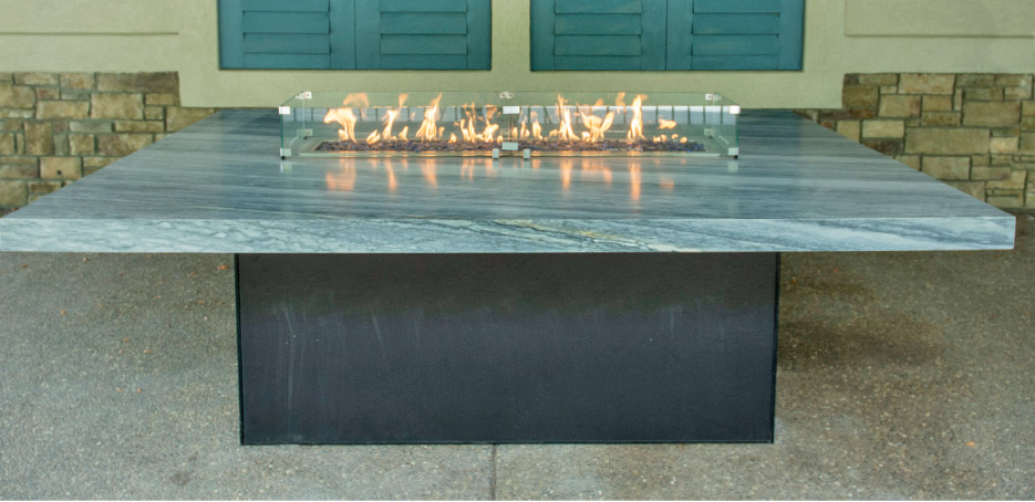 This quartzite fire table rests on a Dekton cabinet with aluminum framing and access doors to the propane assembly – part of Artistic Granite and Marble’s expanding outdoor display area.