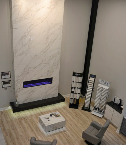 A 2-story fireplace in Neolith Calacatta dominates one end of the showroom. 