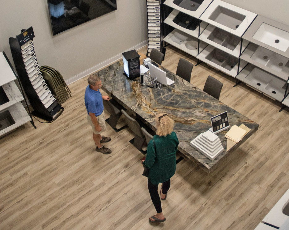 Other  vignettes include a Cambria Bentley shower, a book-matched conference table in quartzite 