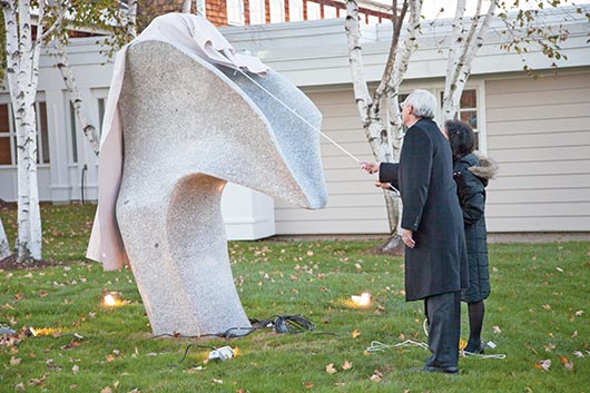Now the cornerstone of Acadia Hospital, Maine artist Andreas von Huene’s “Zephyr” is unveiled by Hospital President and CEO Dan Coffey and Max Kagan Family Foundation representative Leslie Kagan.