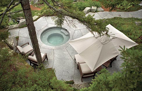 A spa work of art that sits on the coast of Maine, built using two 50,000 pound blocks of Freshwater Pearl Granite. “We are known for using rather large stones but they are getting hard to find these days,” said Jeff Gammelin, Owner, Freshwater Stone, “so what we do is take the weathered faces of the quarry ledges and blocks we cut and saw them off at 6 to 8 inches thick and most times end up with a beautiful 5-inch to 8-inch thick piece of granite with moss and lichen on it and use them in our residential and commercial work.”